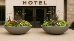 Two wide dish shaped planters in front of a hotel entrance